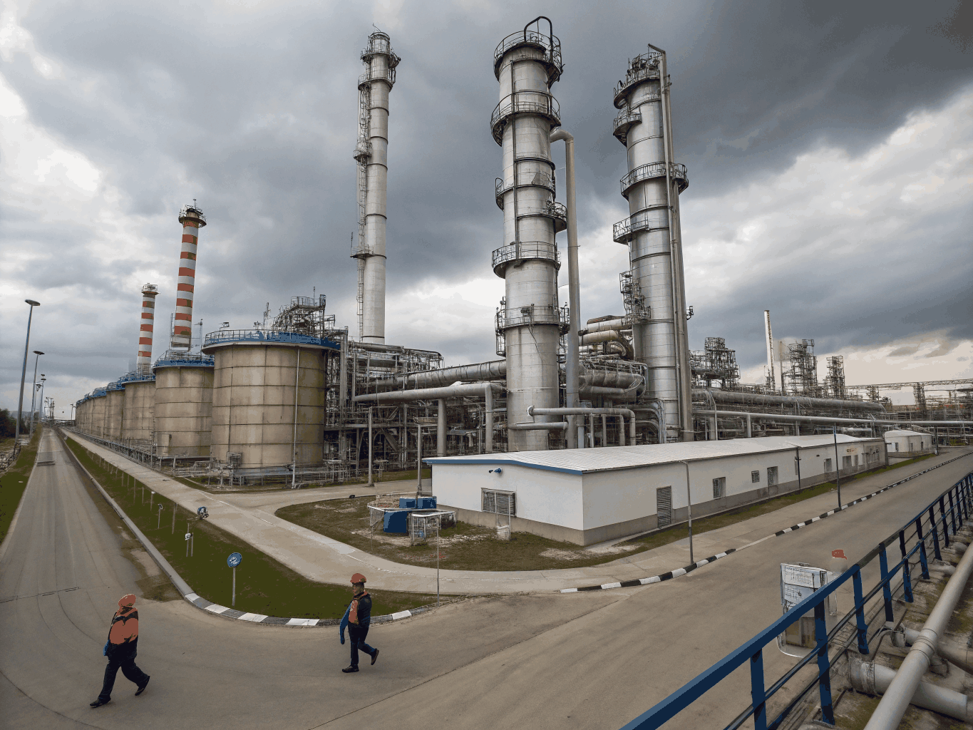 Industrial chemical manufacturing facility with automated storage and distillation towers
